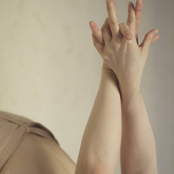 Close-up of a person demonstrating strength and focus during a physical practice, with a mono and lime filter effect.