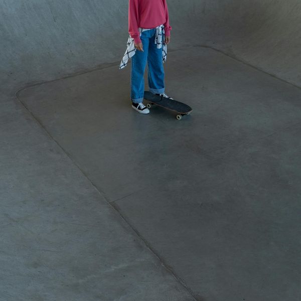 Person practicing a balancing movement in a minimalist environment with a mono and lime filter.